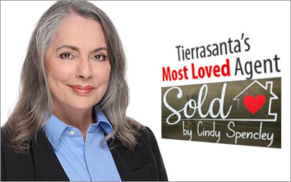 Cindy Spencley headshot with real estate sold sign