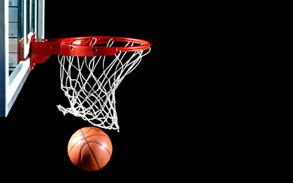 Basketball hoop and ball going through the hoop